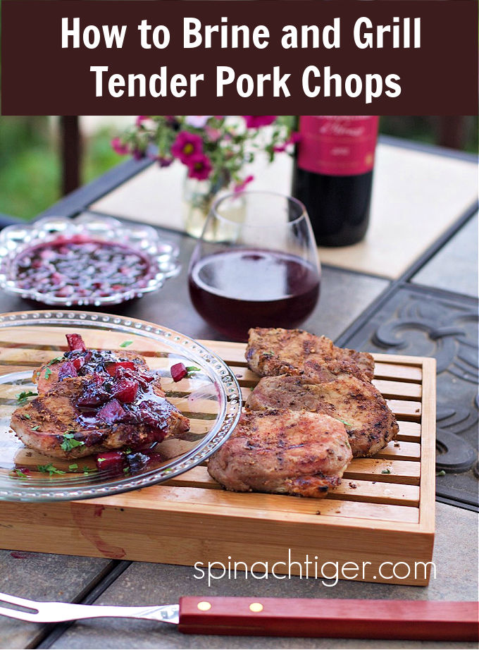 Brine ribeye pork chops to and grill the most tender pork chops ever. Top with a blueberry peach compote. #ribeyeporkchops #grilledporkchops #blueberrycompote #spinachtiger via @angelaroberts