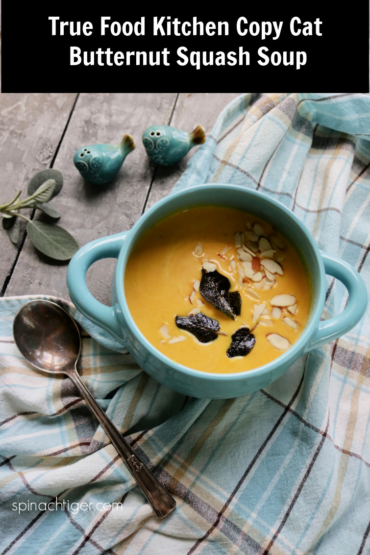 Copycat True Food Kitchen Butternut Squash Soup. Fresh Ginger, Coconut Milk, Cayenne, Turmeric make for a creamy and delicious vegan soup. #Truefoodkitchen #butternutsquashsoup #vegan #coconutmilk #butternutsquash #spinachtiger via @angelaroberts